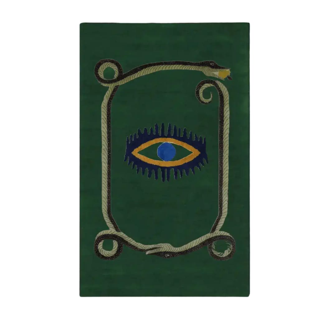 A unique area rug featuring a striking design with a central yellow evil eye surrounded by a coiling snake on a rich green background. This hand-tufted wool rug adds an artistic touch to any space, making it perfect for use as a kitchen rug, hallway runner rug, or in the dining room and bedroom. Its vintage charm and bold design make it a standout piece for those looking to enhance their decor with a stylish wool rug.