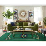 Modern living room with a green sofa, a contemporary snake wool rug, coffee table, and decorative elements.