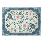 Top view of a Soft Bloom Canopy hand-tufted area rug featuring a floral design with delicate pink and blue flowers. This wool rug is perfect for adding elegance to large living rooms, combining beauty with the practicality of a high-quality area rug.