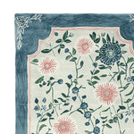This image showcases a beautifully detailed area rug featuring a floral design. The Soft Bloom Canopy Hand Tufted Rug is crafted from high-quality wool, presenting a combination of elegant pink and blue flowers against a soft cream background. Ideal for adding a touch of warmth and style, this wool rug is perfect for enhancing the ambiance of large living rooms.