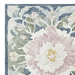 Detailed close-up of the Soft Bloom Rhapsody Hand Tufted Area Rug, showcasing an intricate floral design in pastel hues. This wool rug is perfect for adding elegance to living rooms, available in an 8x10 size.