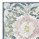 Detailed close-up of the Soft Bloom Rhapsody Hand Tufted Area Rug, showcasing an intricate floral design in pastel hues. This wool rug is perfect for adding elegance to living rooms, available in an 8x10 size.