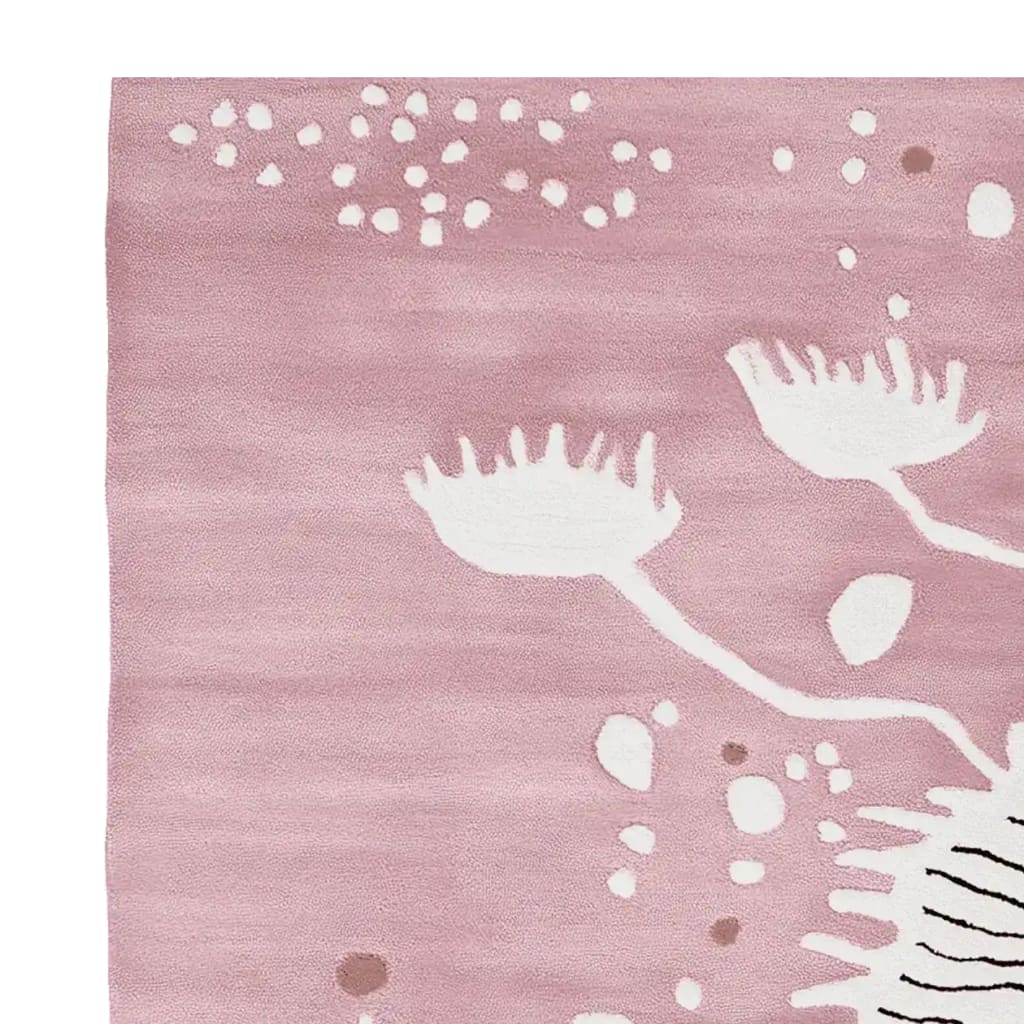 Close-up view of the Soft Coral Bloom Hand Tufted Rug, showcasing its elegant design with abstract white floral patterns against a soft pink background. This contemporary wool rug is perfect for adding a touch of sophistication to living rooms. Ideal as an area rug, it fits seamlessly into an 8x10 space, making it a stylish choice for modern living room decor.