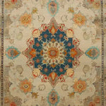 A beautifully detailed hand-knotted area rug featuring a rich floral design with a vintage Persian aesthetic. The central medallion is highlighted in deep blue and surrounded by intricate patterns in warm tones, perfect for enhancing any living room space. Ideal as an 8x10 living room rug, this floral rug adds elegance and charm to your home decor.