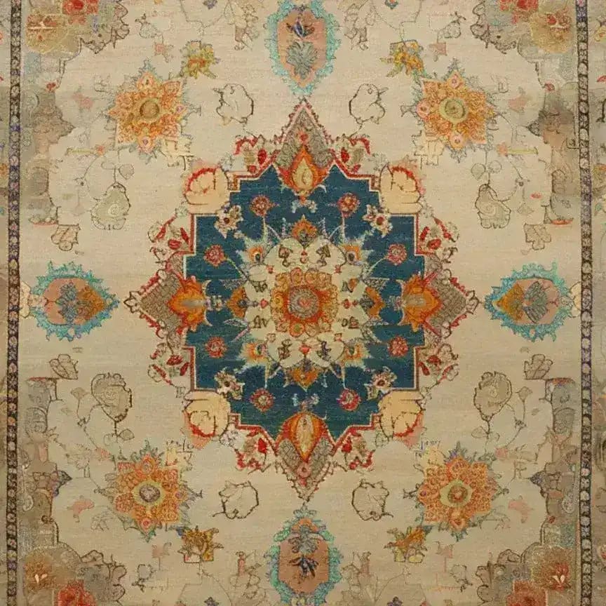 A beautifully detailed hand-knotted area rug featuring a rich floral design with a vintage Persian aesthetic. The central medallion is highlighted in deep blue and surrounded by intricate patterns in warm tones, perfect for enhancing any living room space. Ideal as an 8x10 living room rug, this floral rug adds elegance and charm to your home decor.