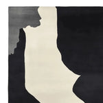 Contemporary area rug featuring an abstract design in black, gray, and white, ideal for modern living rooms. This 8x10 wool rug showcases a hand-tufted texture, perfect for adding a stylish touch to your home decor.