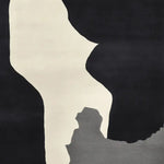 A contemporary area rug with an abstract black, white, and gray design, perfect for adding a modern touch to your living room. This wool rug is hand-tufted and ideal for an 8x10 space.