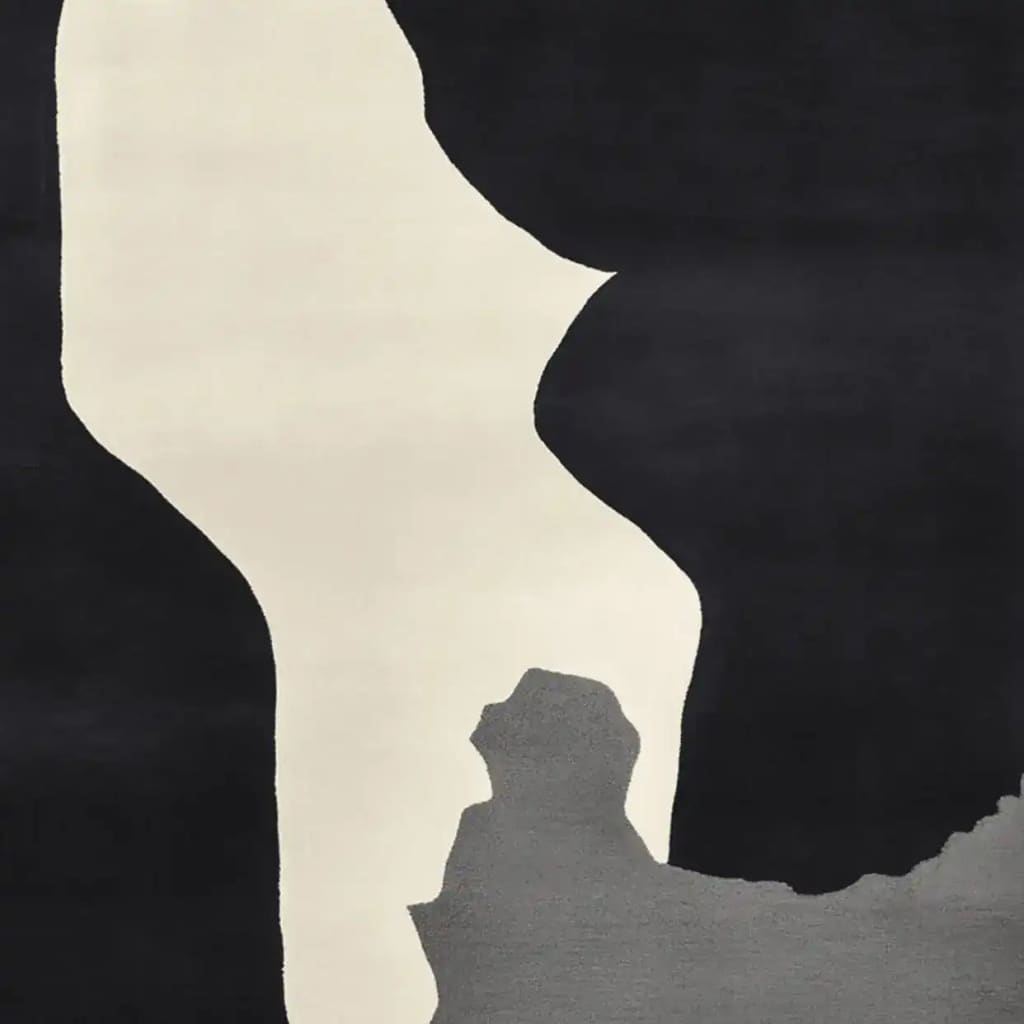 A contemporary area rug with an abstract black, white, and gray design, perfect for adding a modern touch to your living room. This wool rug is hand-tufted and ideal for an 8x10 space.