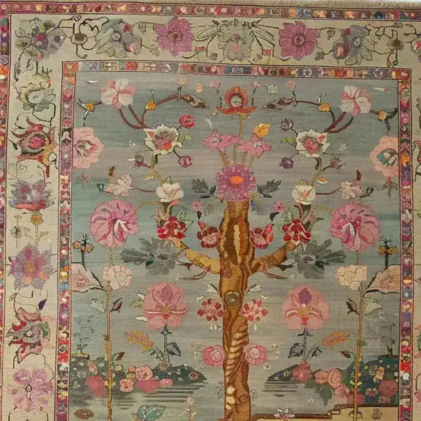 A beautifully designed hand-knotted area rug featuring intricate floral patterns, perfect for enhancing a living room. This Soft Harmony tapestry showcases Persian-inspired motifs with vibrant blooms and delicate branches, offering a classic and elegant touch to any space.