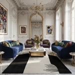 Luxurious living room with blue sofas, gold coffee table, an abstract wool rug, and decorative elements.