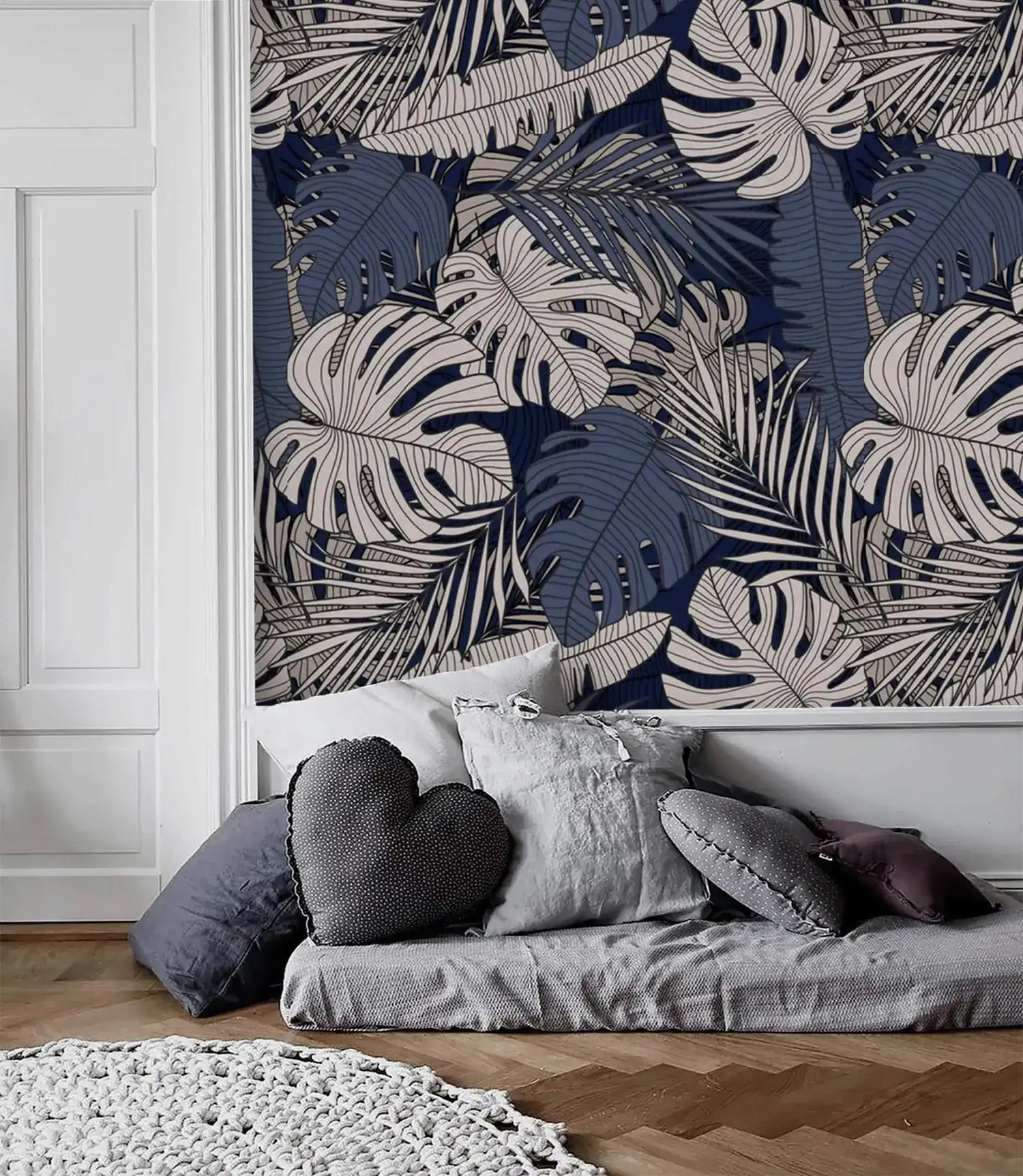 Soft pink floral wallpaper with large blooms and sage leaves, shown in room setting with wood side table