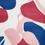 Top view of a contemporary wool area rug showcasing an abstract design with bold red, blue, and pink shapes. Perfect for adding a modern touch to living room spaces, this hand-tufted rug combines style and comfort.