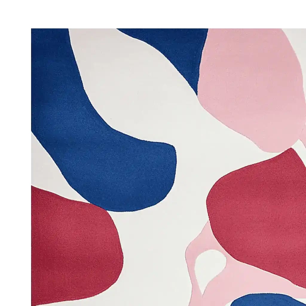 Top view of the Soft Shapes Collide Hand Tufted Area Rug, showcasing its abstract design with bold colors like blue, red, and pink. This contemporary wool rug is perfect for adding a modern touch to living room spaces, making it an ideal choice for those seeking stylish rugs for living room decor.