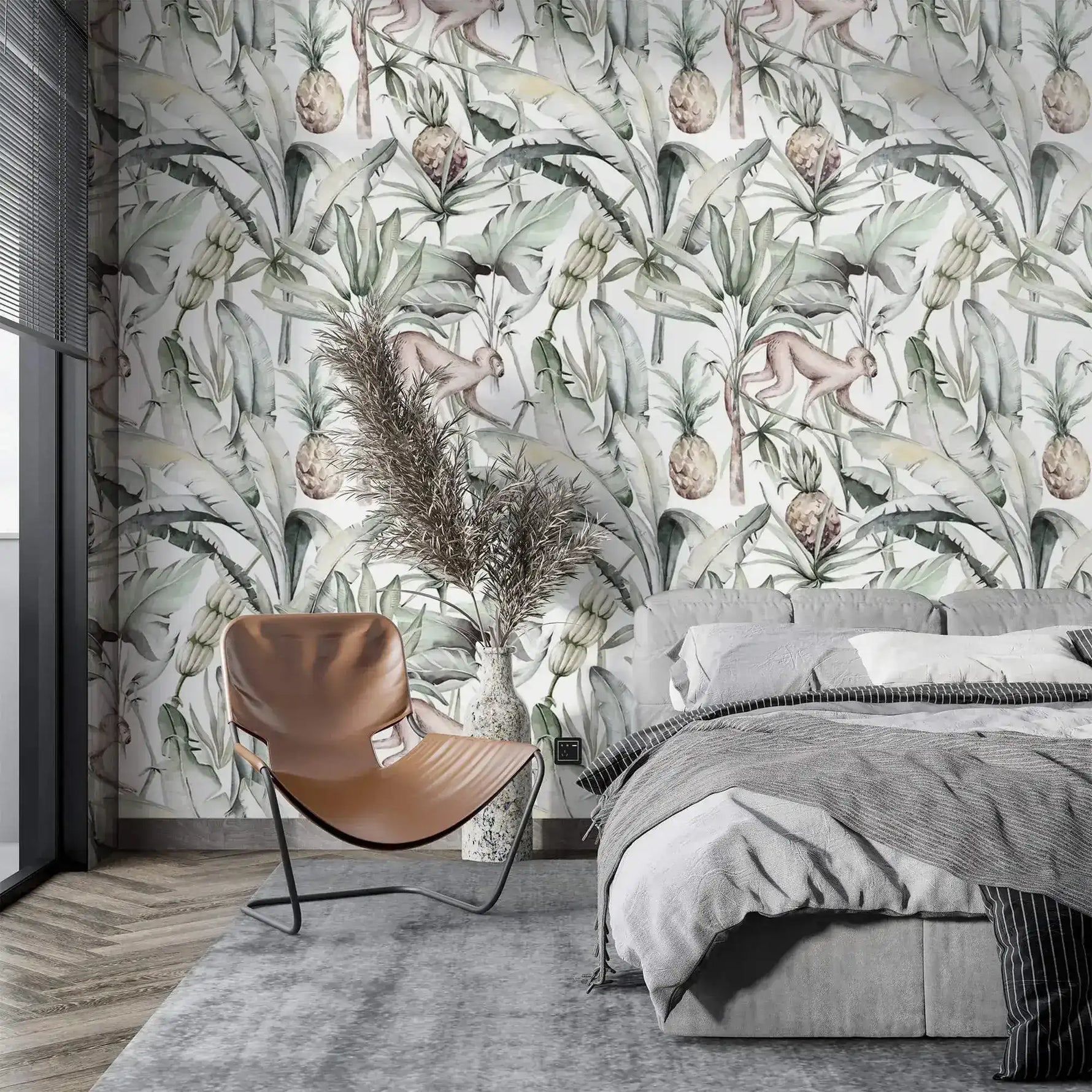 Soft watercolor tropical jungle wallpaper with palms and pineapples in bedroom with tan chair and grey bed
