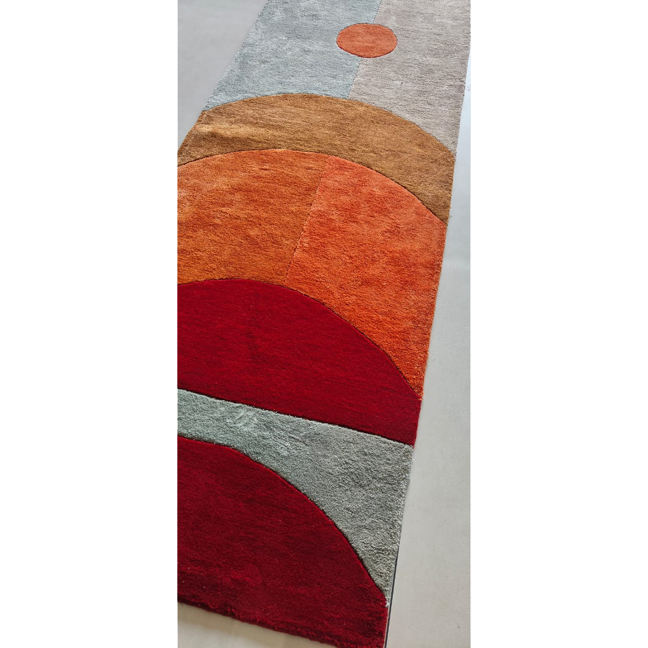 Full Solar Eclipse runner, overlapping arcs of red, orange, tan and grey with a coral circle