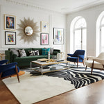 The Solar Symphony Hand Tufted Rug is a stunning contemporary area rug featuring bold, wavy black patterns against a beige background, accented with a vibrant orange circle. Ideal for a dining room or large living room, this wool rug adds a sophisticated touch to any space.