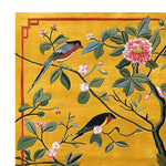 This hand-tufted area rug showcases a vibrant design of songbirds and blossoms, perfect for adding a contemporary touch to your living room. The wool rug features intricate details on a golden background, ideal for those seeking rugs for living room in an 8x10 size.