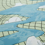 Close-up of a rug with abstract design featuring blue, green, and white colors.