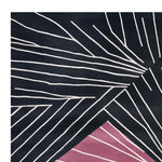 Close-up view of a contemporary square area rug, featuring a striking abstract design with white linear patterns on a dark background and a touch of pink. Perfect wool rug for modern living rooms, adding a bold statement to any space.