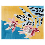 A vibrant hand-tufted area rug showcasing a contemporary design with abstract floral patterns in pink and black on a yellow and blue background, perfect for adding a touch of modern elegance to living room spaces. This wool rug is ideal for those seeking 8x10 living room area rugs.