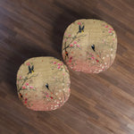 Two Spring Blossom Birds Floor Pillows overhead on dark wood floor, pair view with delicate floral bird print in gold