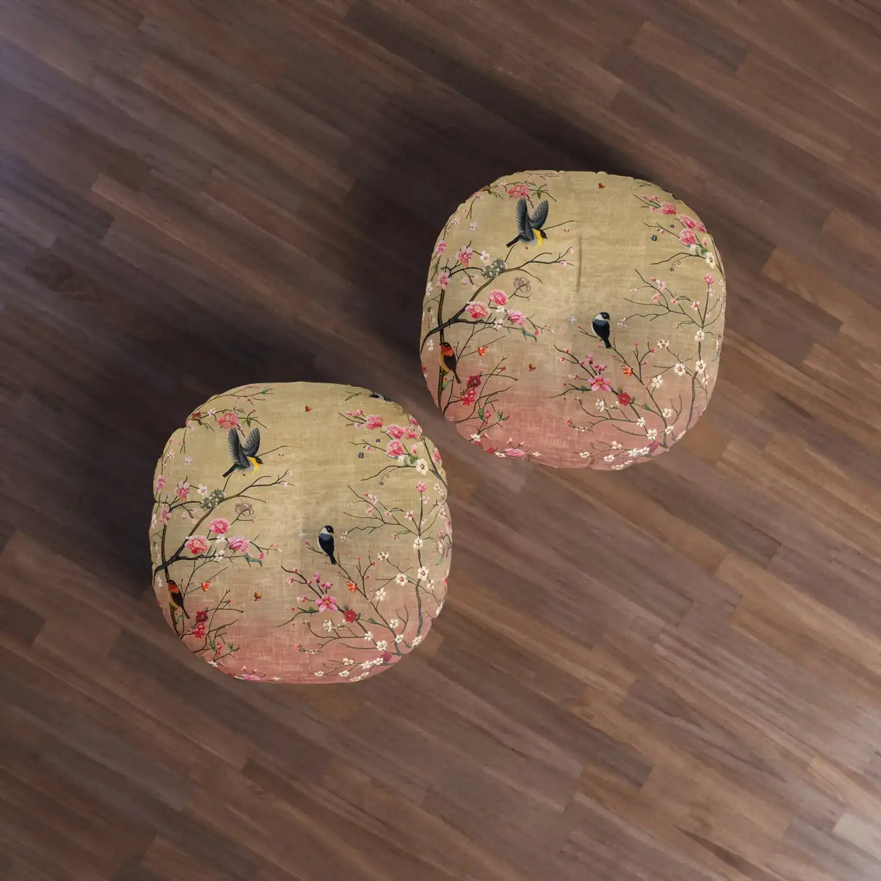 Two Spring Blossom Birds Floor Pillows on wood floor, overhead pair view with floral bird pattern in gold and rose tones