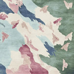 Vibrant abstract pattern on a hand tufted area rug, featuring a mix of soft blues, greens, and pinks. This contemporary wool rug is ideal for adding a touch of elegance to living room area rugs.