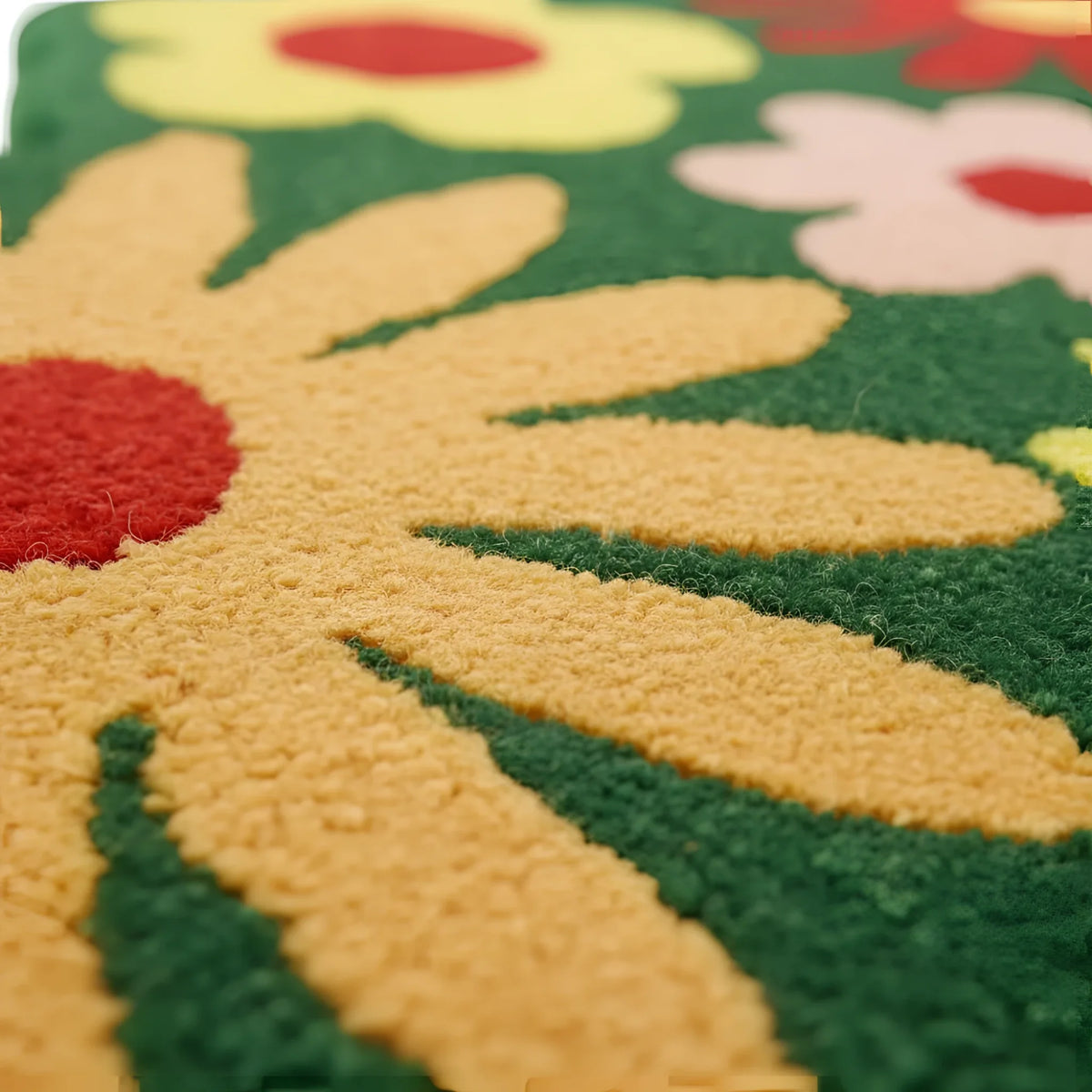 Close-up of a colorful floral rug with vibrant flowers and green background.