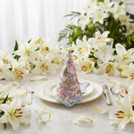 Decorative napkin on a plate with flowers and cutlery in the background