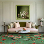 A beautifully decorated living room featuring a Springtime Serenade Hand Tufted rug. This large square area rug, perfect for living rooms, is crafted from wool and showcases vibrant floral and bird patterns. The rug complements the elegant pink and green sofa and the classic art piece on the wall, creating a harmonious and inviting setting.