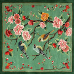 Springtime Serenade Hand Tufted Rug featuring an elegant design with birds perched on branches amidst colorful blossoms. This square wool rug, perfect for living rooms, combines vibrant pinks, yellows, and greens, adding a touch of nature to your decor. Ideal as a large area rug, it enhances any living space with its artistic and cozy appeal.
