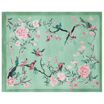 A beautifully crafted area rug featuring a springtime theme with intricate floral and bird designs. This elegant wool rug is perfect for adding a touch of nature to your living room, showcasing vibrant pink and green hues against a soft background.
