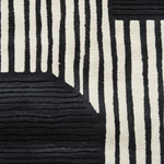 Close-up of a black and white striped patterned rug.