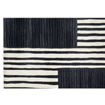 The Star Dance Hand Tufted Wool Rug features a striking black and white geometric pattern, perfect for adding a contemporary touch to your space. Ideal as a runner rug for kitchens, bathrooms, or hallways, this wool rug combines style and functionality effortlessly.