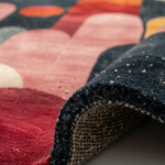 Close-up of a multicolored textured rug with a focus on the edge.