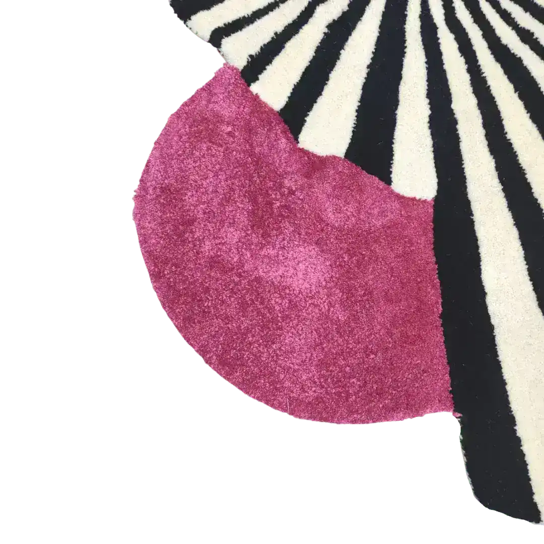 Close-up of a vibrant wool area rug, showcasing a striking design with bold black and white stripes alongside a rich pink section. Perfect for adding a touch of vintage charm to large living rooms, this hand-tufted rug is an ideal choice for those seeking stylish area rugs for their living space.