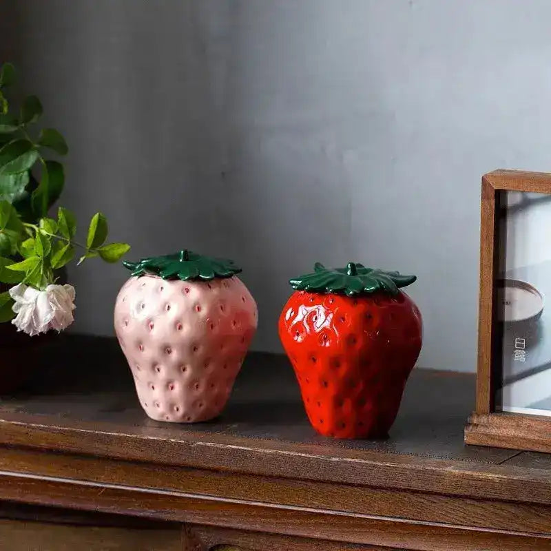 Strawberry Storage Jar is a charming and functional kitchen container designed to store food while adding a touch of whimsy to your space. Typically made of ceramic, glass, or plastic, these jars are shaped like strawberries or feature strawberry motifs. The jar often has a tight-sealing lid to preserve the freshness of stored items, such as fruits, jams, or even dry goods like sugar, flour, or snacks.

