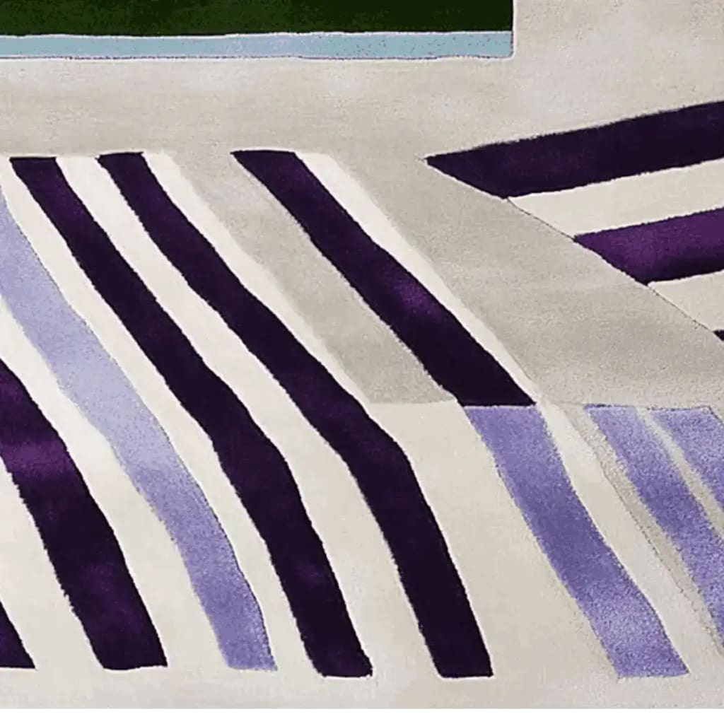 This contemporary area rug features a striking collision of stripes in bold purple and soft lavender, ideal for large living rooms. The wool rug showcases a modern design with a blend of geometric patterns, enhancing any space's aesthetic appeal.