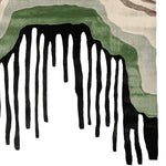 A contemporary hand-tufted area rug featuring an abstract design with cascading black and green patterns, ideal for modern living rooms. This wool rug adds a touch of elegance and style, perfect as a centerpiece among living room area rugs.