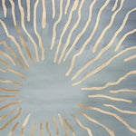 Stylish area rug with an abstract design featuring radiating golden lines on a soothing blue background, perfect for contemporary living rooms. This wool rug combines elegance and comfort, enhancing any space.