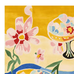 Bright and colorful hand tufted wool rug featuring a playful floral and abstract design against a vibrant yellow background. Perfect for adding a splash of color to any contemporary living room, this area rug brings a touch of modern artistry to your space.