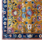 A vibrant area rug featuring a sunlit floral symphony design, showcasing an intricate pattern of colorful flowers on a warm yellow background. The rug is hand tufted from wool, perfect for large living rooms. This floral rug is an ideal choice for those looking for living room rugs sized 8x10.