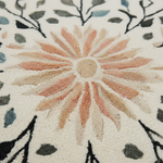 Close-up of a textured floral design with a central flower and leaf patterns.