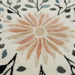 Close-up of a textured floral design with a central flower and leaf patterns.