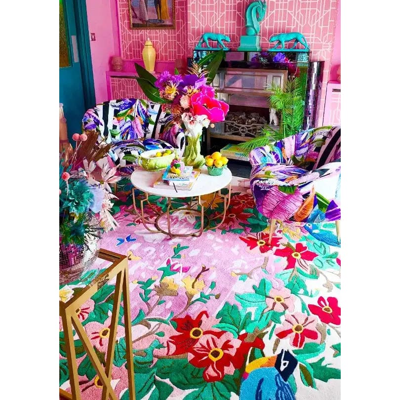 Vibrant living room featuring a Sunrise Bloom Hand Tufted Round Area Rug with a colorful floral design. This large wool rug adds a lively touch to the space, perfectly complementing the eclectic decor. Ideal for those seeking unique rugs for living room settings.