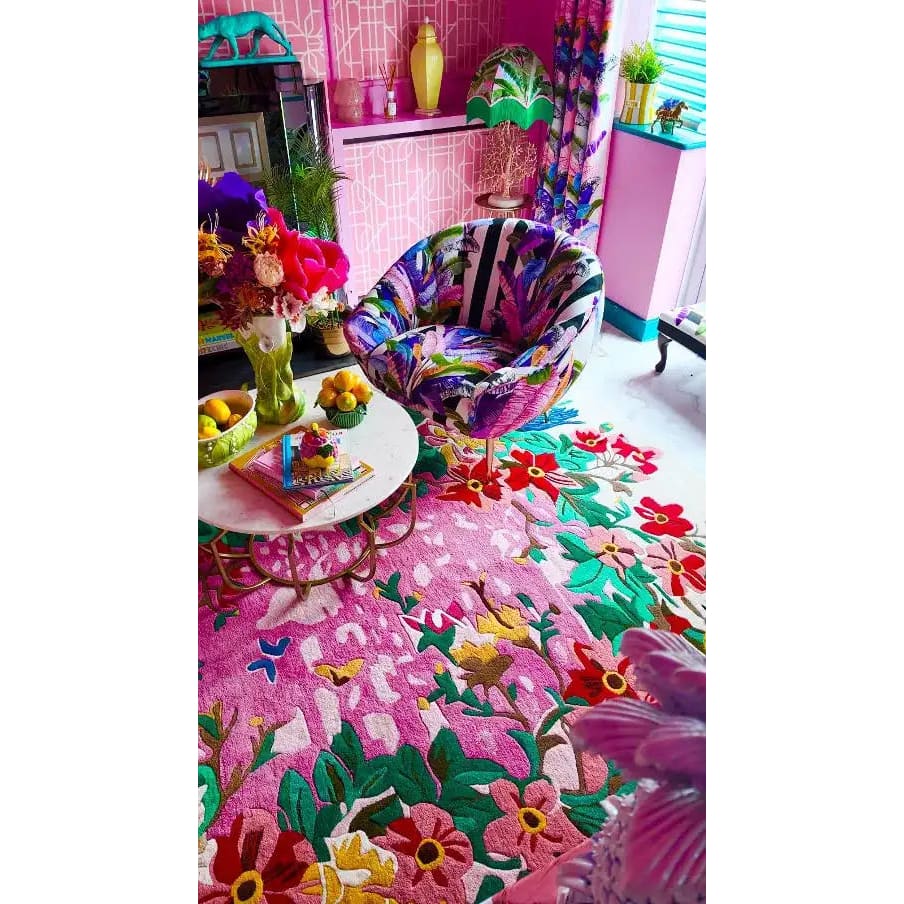 Bright and colorful living room featuring a Sunrise Bloom Hand Tufted Round Rug. This large area rug is an exquisite wool rug with vibrant floral patterns, perfect for adding a splash of color to your living room. The round rug design enhances the room's aesthetics, making it a standout choice for rugs for living room settings.