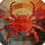 A vibrant Sunset Crab Hand Tufted Round Rug made of wool, perfect for adding a touch of coastal charm to large living rooms. This round rug features a striking crab design with warm hues, ideal for those seeking unique large area rugs for their living room.