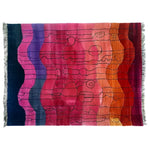 Vibrant and contemporary area rug perfect for living room decor, featuring a hand-knotted wool design with abstract patterns in rich sunset hues. Ideal for adding a pop of color and style as a living room area rug.