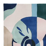 This image showcases a vibrant Surreal Vision Hand Tufted Area Rug, perfect for adding a contemporary touch to any living room. The abstract design features bold blue, teal, and neutral tones, making it an ideal wool rug for those seeking stylish area rugs for living room. Sized approximately 8x10, this rug combines artistry with function.