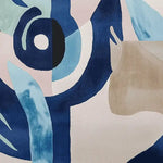 Close-up of the Surreal Vision Hand Tufted Area Rug featuring abstract patterns in shades of blue and beige. This contemporary wool rug is perfect for adding a touch of artistic flair to your living room. Ideal for spaces needing an 8x10 area rug, offering both style and comfort.